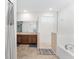 Main bathroom with double sinks, shower, and bathtub at 6115 Sw 74Th Ct, Ocala, FL 34474