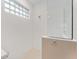 Bright bathroom with shower and glass block window at 6115 Sw 74Th Ct, Ocala, FL 34474