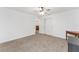 Well-lit bedroom with carpeting and access to other rooms at 6115 Sw 74Th Ct, Ocala, FL 34474