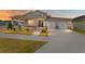 Two-story house with a front porch, two-car garage, and landscaped yard at dusk at 6115 Sw 74Th Ct, Ocala, FL 34474