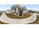 Two-story home with a front porch, two-car garage, and landscaped yard at 6115 Sw 74Th Ct, Ocala, FL 34474