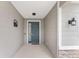 Inviting front door entrance with a gray door and stone accents at 6115 Sw 74Th Ct, Ocala, FL 34474