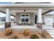 Front porch with rocking chairs and a small table at 6115 Sw 74Th Ct, Ocala, FL 34474