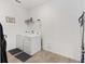 Bright laundry room with washer, dryer, and shelving at 6115 Sw 74Th Ct, Ocala, FL 34474