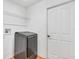 Laundry room with washer, dryer, and built-in shelving at 7043 Hemlock Crse, Ocala, FL 34472