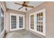 Spacious screened porch with double French doors and a concrete floor at 7043 Hemlock Crse, Ocala, FL 34472