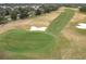 Aerial view of a section of the golf course showing a green and sand traps at 7824 Se 166Th Smallwood Pl, The Villages, FL 32162