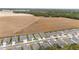 Aerial view of houses and street next to open field at 9229 Sw 52Nd Place Rd, Ocala, FL 34481