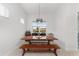 Bright dining area featuring a long wooden table and bar cart at 9229 Sw 52Nd Place Rd, Ocala, FL 34481