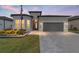 One-story home with gray exterior, two-car garage, and landscaped yard at 9229 Sw 52Nd Place Rd, Ocala, FL 34481