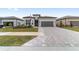One-story home with gray exterior, two-car garage, and landscaped yard at 9229 Sw 52Nd Place Rd, Ocala, FL 34481