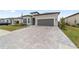 Gray house with dark gray garage door and paved driveway at 9229 Sw 52Nd Place Rd, Ocala, FL 34481