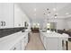 Modern kitchen with white cabinets, quartz countertops and island at 9229 Sw 52Nd Place Rd, Ocala, FL 34481