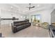 Open concept living space with leather couches and kitchen views at 9229 Sw 52Nd Place Rd, Ocala, FL 34481