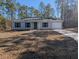 Newly constructed home with a grassy yard and driveway at 963 Sw Temple Heights Ct, Dunnellon, FL 34431