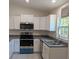 Modern kitchen with stainless steel appliances and ample counter space at 963 Sw Temple Heights Ct, Dunnellon, FL 34431