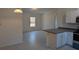 Open kitchen features modern white cabinets and granite countertops at 963 Sw Temple Heights Ct, Dunnellon, FL 34431