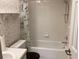 Clean bathroom with tub, shower, and seashell wallpaper at 10814 Sw 83Rd Ave, Ocala, FL 34481