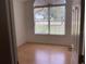 Bright bedroom with wood flooring and a large window at 10814 Sw 83Rd Ave, Ocala, FL 34481