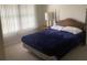 Bedroom with double bed, wooden nightstand, and window coverings at 10814 Sw 83Rd Ave, Ocala, FL 34481