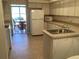 Kitchen with light wood cabinets, island, and view of dining area at 10814 Sw 83Rd Ave, Ocala, FL 34481