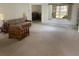 Spacious living room with carpeted floor and view of bedroom at 10814 Sw 83Rd Ave, Ocala, FL 34481