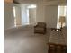 Living room with carpeted floor and wooden furniture at 10814 Sw 83Rd Ave, Ocala, FL 34481