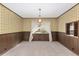 Dining room with wood paneling, patterned wallpaper, and a chandelier at 1105 Ne 17Th Ne Ter, Ocala, FL 34470