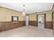 Dining room featuring wood paneling, patterned wallpaper and pass-through to kitchen at 1105 Ne 17Th Ne Ter, Ocala, FL 34470