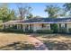 House exterior showcasing a brick walkway and green lawn at 1105 Ne 17Th Ne Ter, Ocala, FL 34470