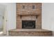 Stone fireplace with wood mantel in the living room at 1105 Ne 17Th Ne Ter, Ocala, FL 34470