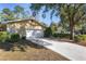 House exterior showcasing a large driveway and garage at 1105 Ne 17Th Ne Ter, Ocala, FL 34470