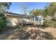 Backyard view of ranch house with deck and partial fence at 1105 Ne 17Th Ne Ter, Ocala, FL 34470