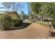 Side yard with gate and view of detached garage at 1105 Ne 17Th Ne Ter, Ocala, FL 34470