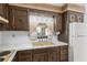 Close-up of kitchen sink and countertops with wood cabinets at 1105 Ne 17Th Ne Ter, Ocala, FL 34470