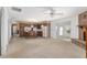 Living room with carpeted floors and a corner stone fireplace at 1105 Ne 17Th Ne Ter, Ocala, FL 34470