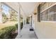 Covered porch with white columns and dark shutters at 1105 Ne 17Th Ne Ter, Ocala, FL 34470