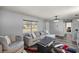 Living room with gray sectional sofa and wood-look floors at 14470 Sw 34Th Terrace Rd, Ocala, FL 34473