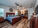 Large bedroom with rustic wooden bed frame and ceiling fan at 14515 Ne 110Th Avenue Rd, Fort Mc Coy, FL 32134