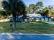 Front yard view of the house with a palm tree at 14515 Ne 110Th Avenue Rd, Fort Mc Coy, FL 32134