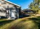 Gray house exterior with white door and pool view at 14515 Ne 110Th Avenue Rd, Fort Mc Coy, FL 32134