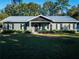 Gray house with black shutters and metal roof at 14515 Ne 110Th Avenue Rd, Fort Mc Coy, FL 32134