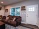 Cozy living room with brown couches and wood floors at 14515 Ne 110Th Avenue Rd, Fort Mc Coy, FL 32134