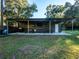 Covered outdoor kitchen with built-in grill and seating at 14515 Ne 110Th Avenue Rd, Fort Mc Coy, FL 32134