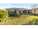 House's back view, showcasing a well-maintained lawn at 16182 Sw 14Th Ave Rd, Ocala, FL 34473