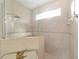 Large bathroom with a walk-in shower, tile surround, and a window at 16182 Sw 14Th Ave Rd, Ocala, FL 34473