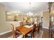 Bright dining room with hardwood floors, chandelier, and view into living area at 16182 Sw 14Th Ave Rd, Ocala, FL 34473