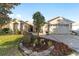 Inviting curb appeal with lush landscaping and a paver driveway at 16182 Sw 14Th Ave Rd, Ocala, FL 34473