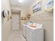 Laundry room with washer, dryer, and shelving at 16182 Sw 14Th Ave Rd, Ocala, FL 34473