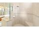 Walk-in shower with glass enclosure and tile surround at 16182 Sw 14Th Ave Rd, Ocala, FL 34473